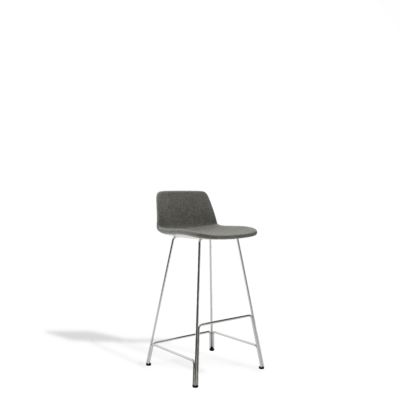 Modern bar stool featuring a textured dark gray upholstered seat and backrest, supported by a slender, chrome four-leg base with a footrest, isolated on white.