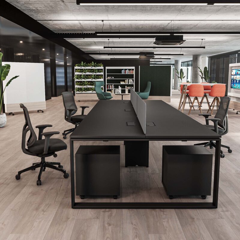 Spacious modern office with a long black collaborative Desk Table, ergonomic chairs, mobile pedestals, and plant walls.